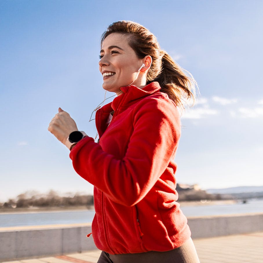 happy woman jogging after NAD+ therapy in Winter Park, FL