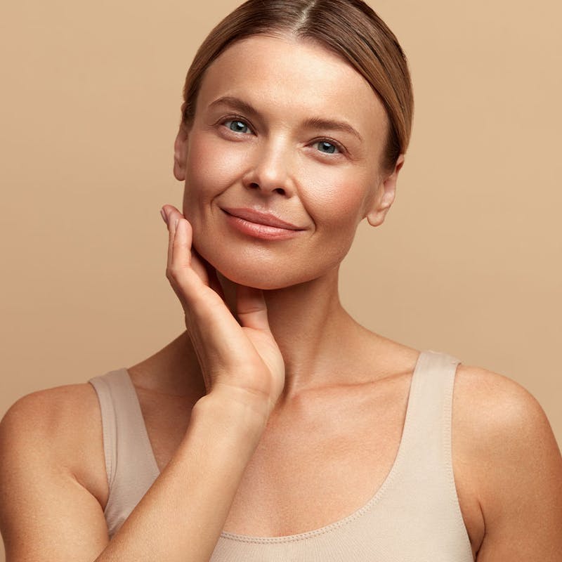 Happy woman after NAD+ therapy from Serotonin Centers.
