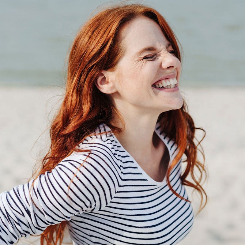 Happy woman after red light therapy from Serotonin Centers.
