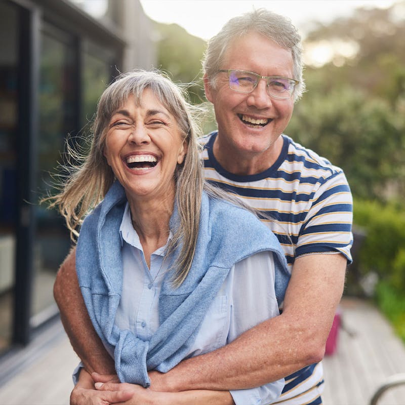 Smiling couple feeling revitalized after hormone therapy at Serotonin Centers.