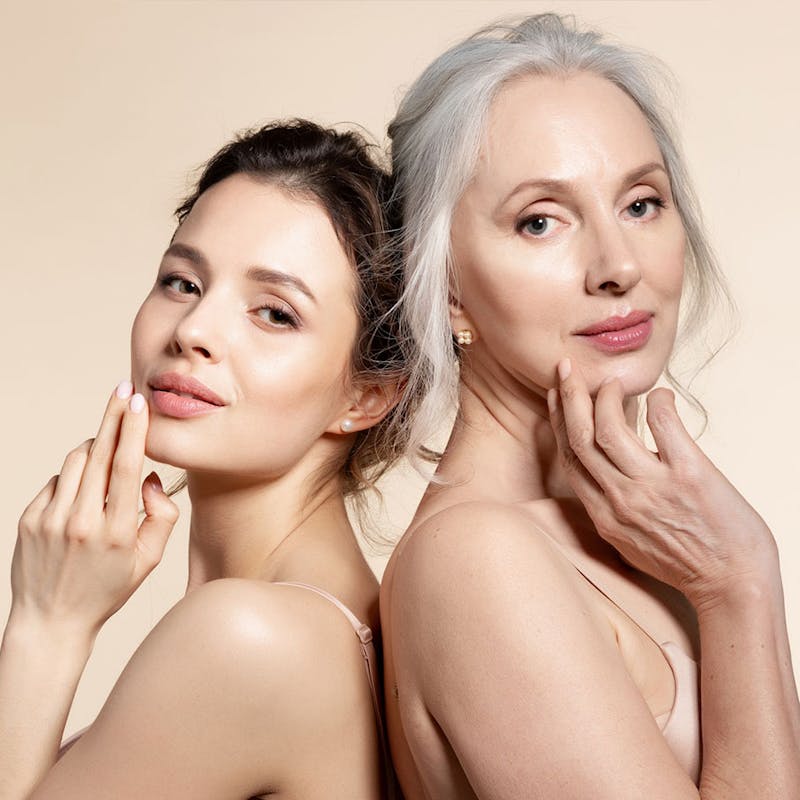 Two beautiful women smiling after refreshed, youthful results from Botox at Serotonin Centers.