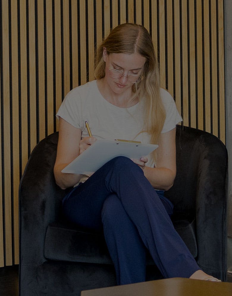 woman filling out paperwork in Serotonin Centers lobby in Del Mar, CA