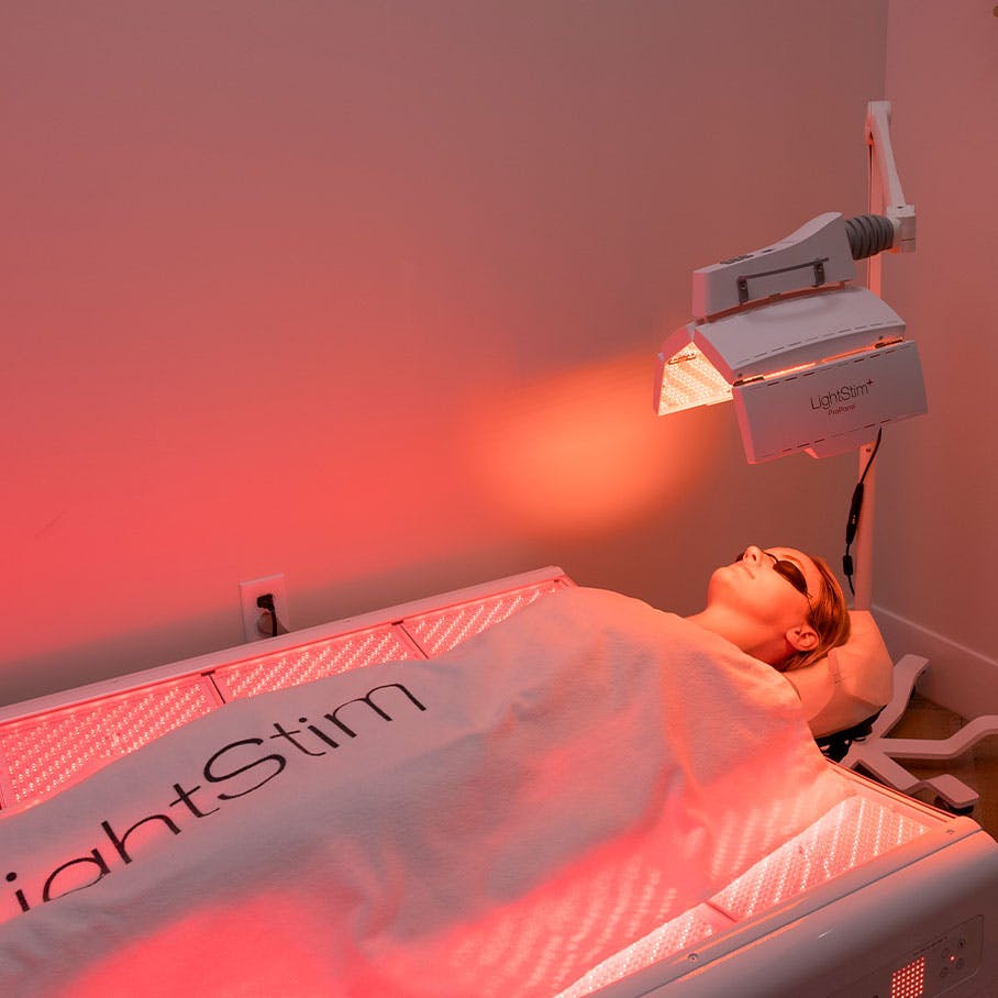 woman receiving red light therapy treatment in Del Mar, CA