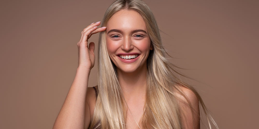 woman happy after bioidentical hormone replacement therapy helped with her hair loss