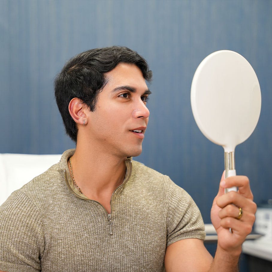 Tampa man examining results of Sculptra in the mirror