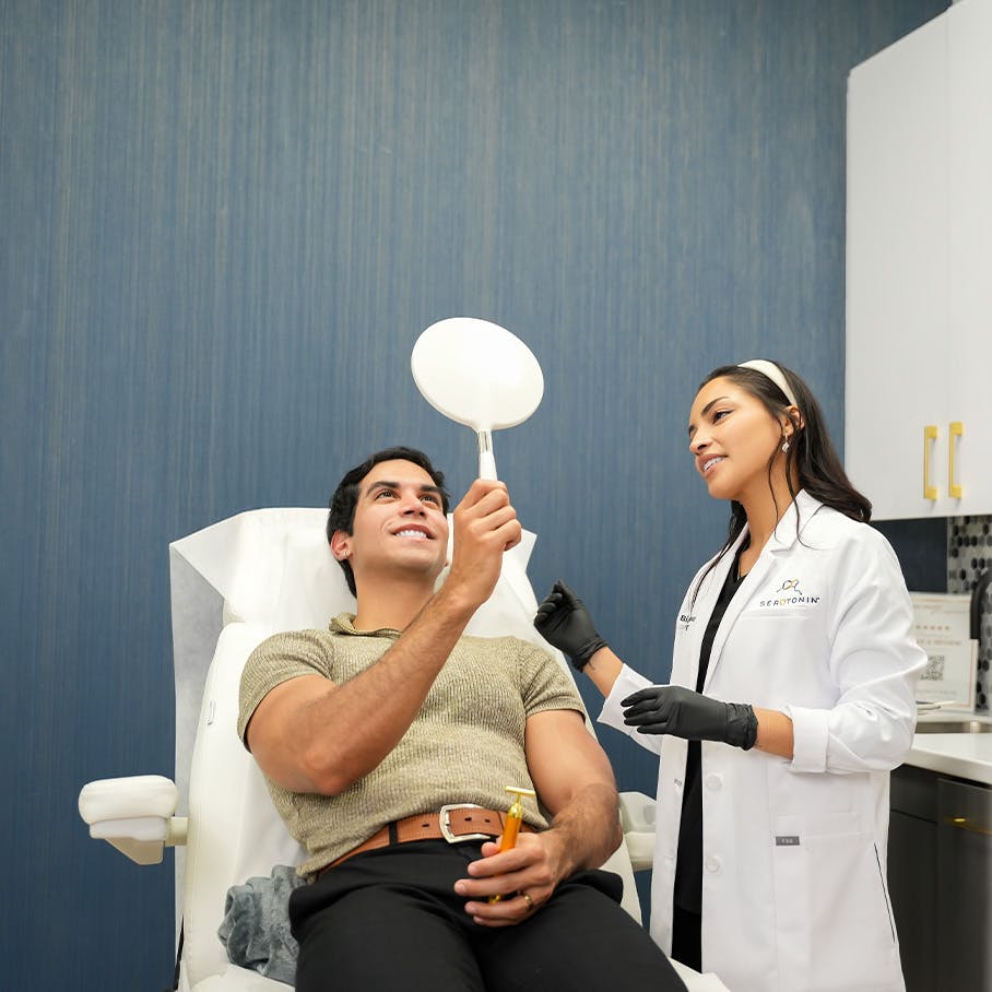 patient looking in the mirror after microneedling in Lake Nona, FL