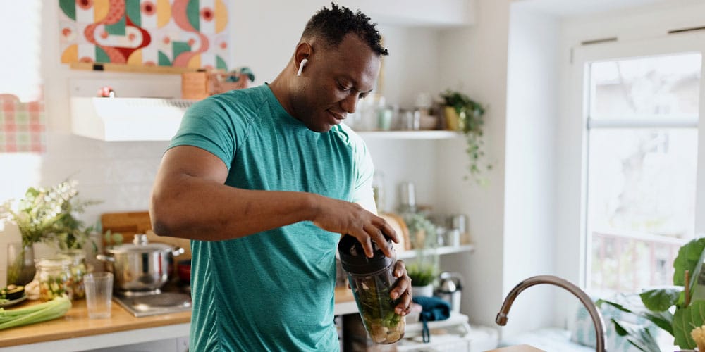 man making a healthy shake after starting testosterone therapy