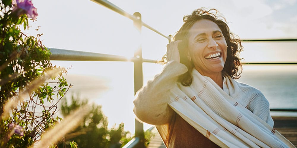 older woman smiling after starting hrt for menopause
