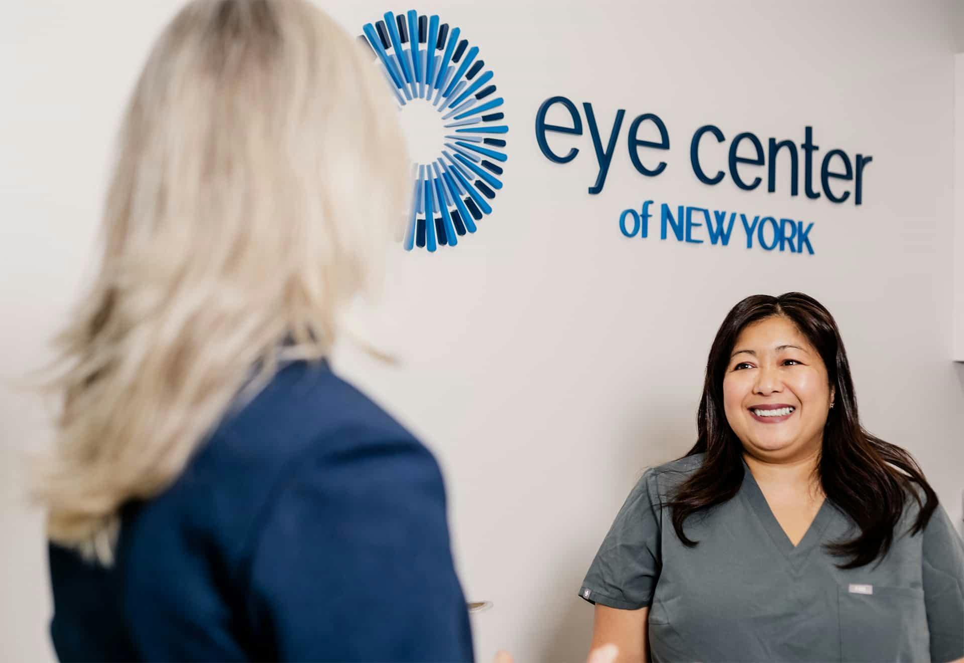 Patient talking with front desk reception