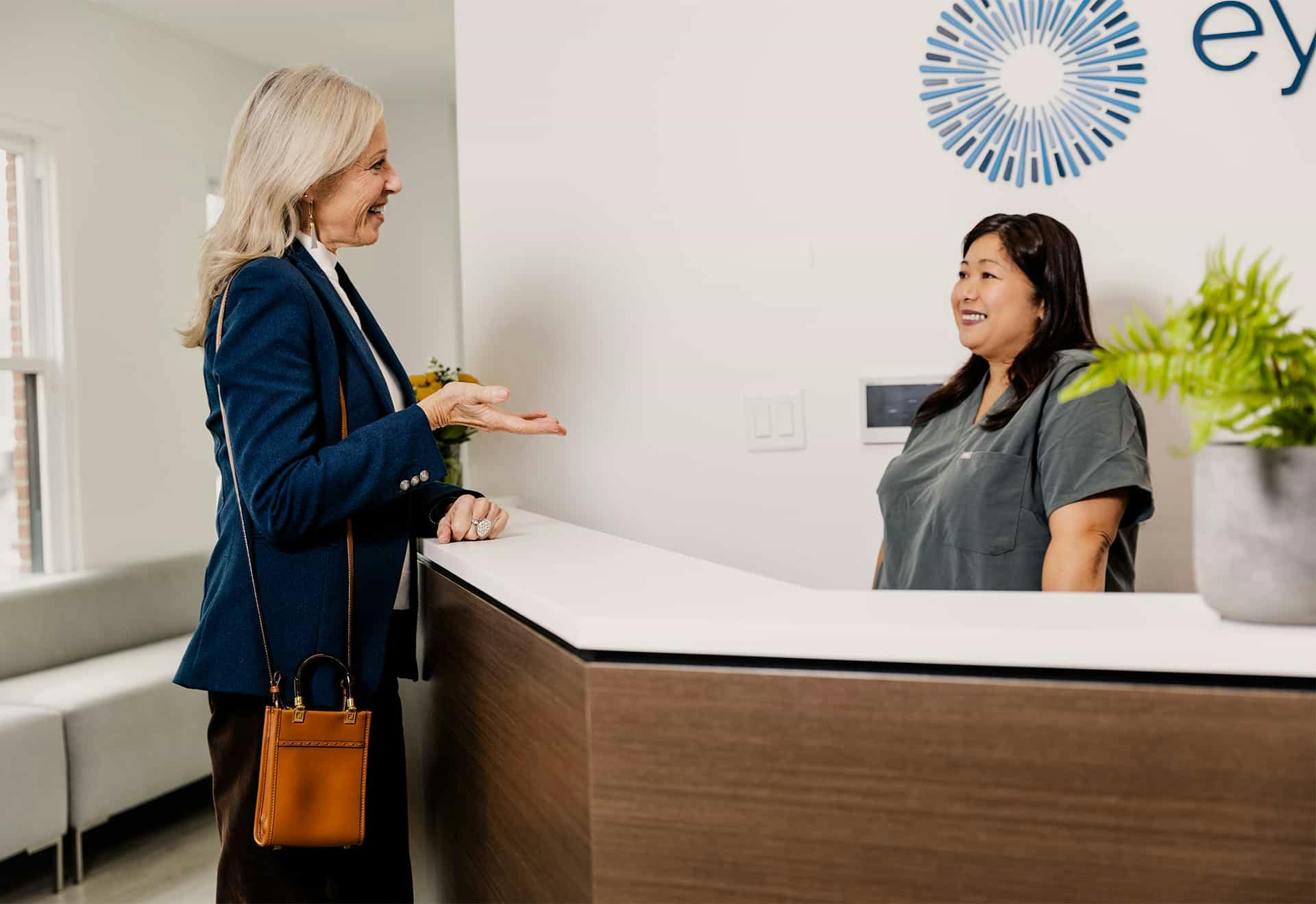 Patient at front desk talking to reception