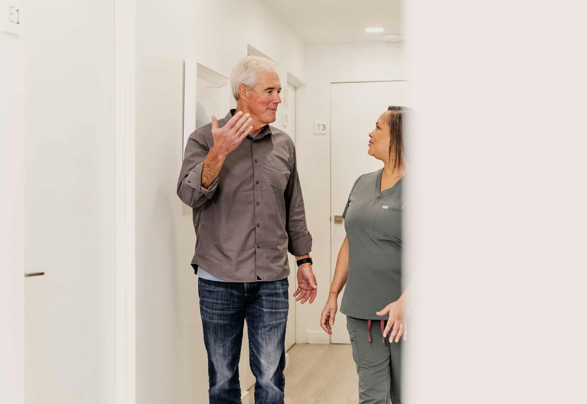 Patient and staff walking down hallway