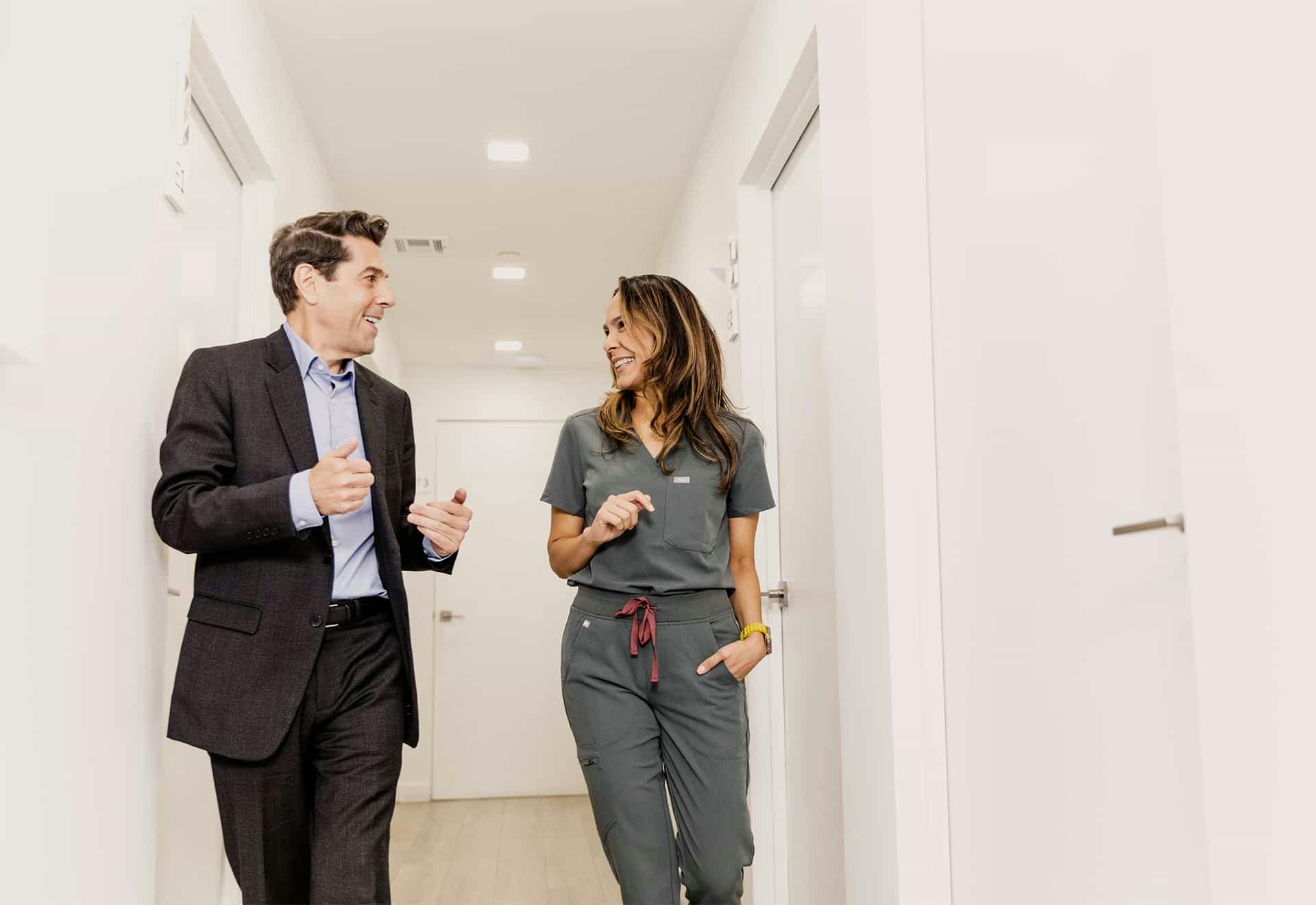 Doctor and patient walking through office