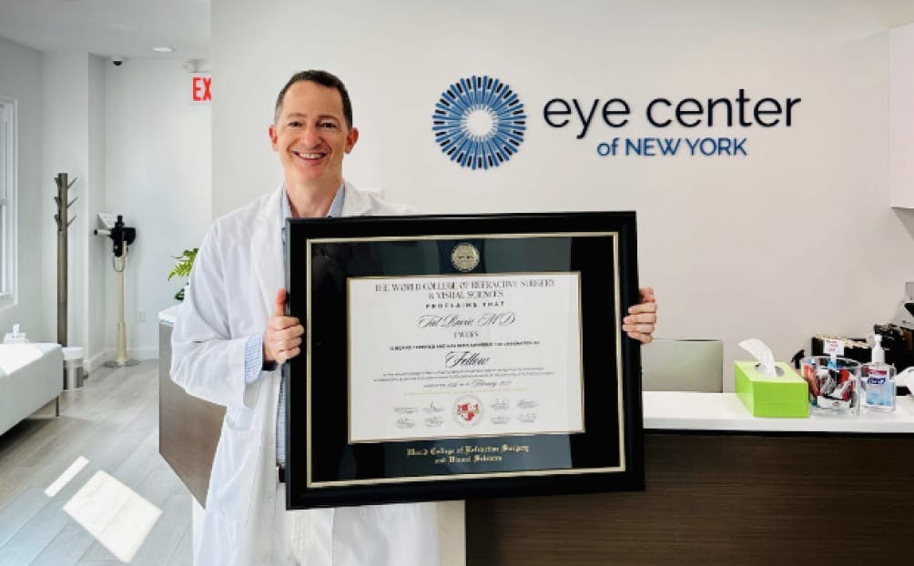 The Doctor holding a certificate at his clinic