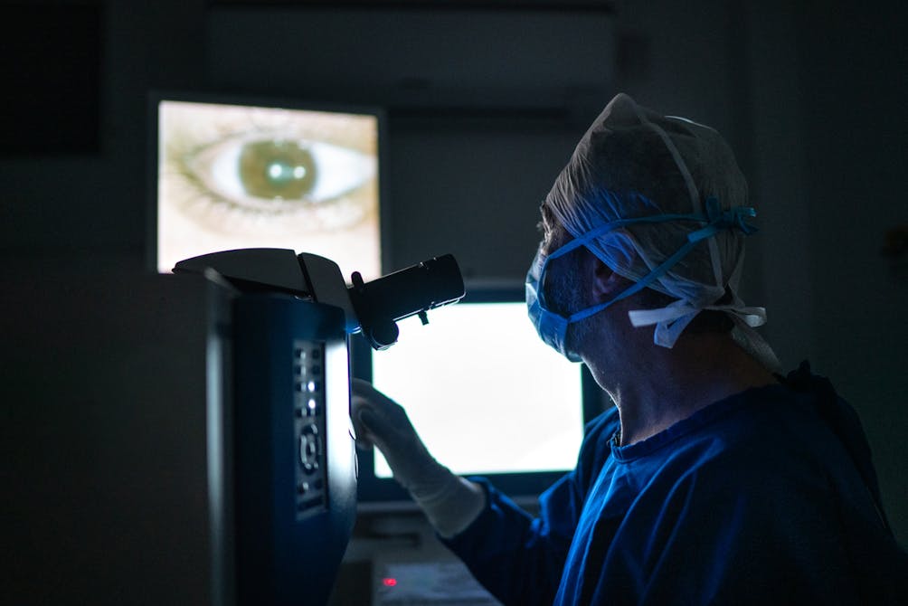 Doctor looking at images on monitor during surgery