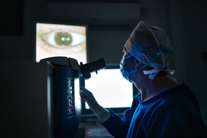 Doctor during surgery, looking at image on monitors