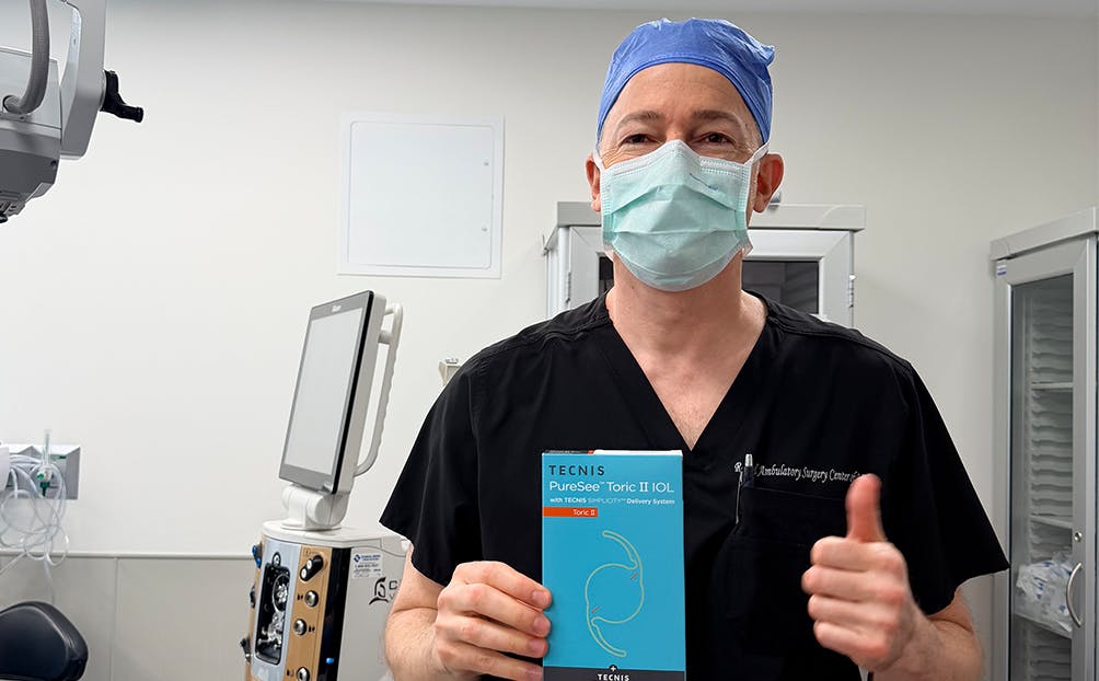 Dr. Tal Raviv Holding a PureSee™ IOL Pamphlet
