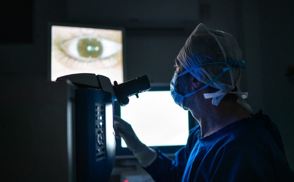 Doctor looking at images on monitor during surgery
