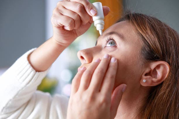 Woman Using Eye Drops
