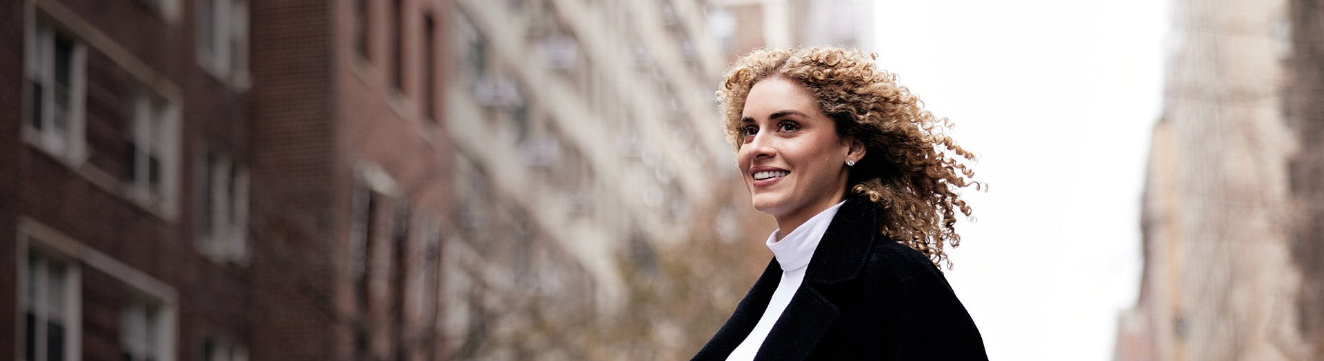 woman with curly hair outside