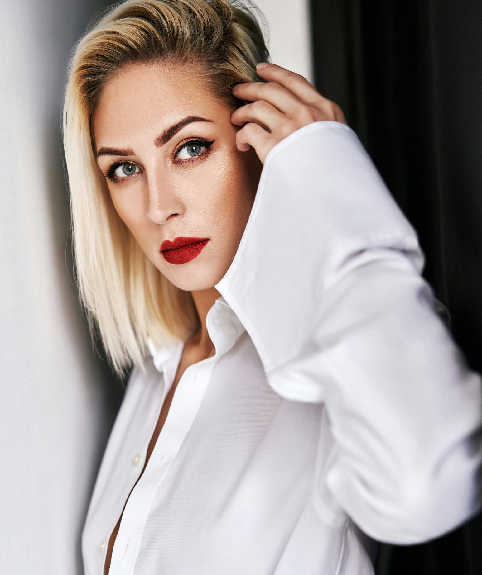 woman moving her hair out of her face