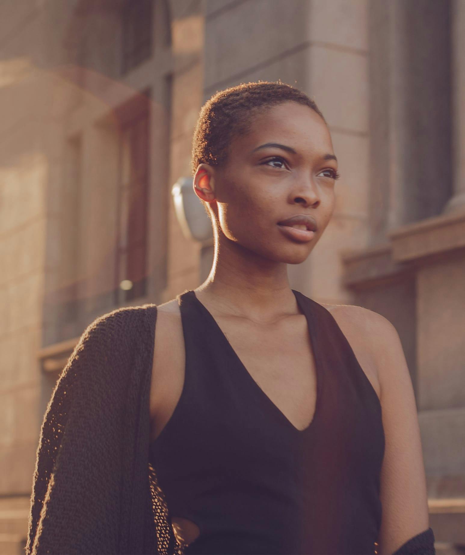 woman in a black dress walking outside