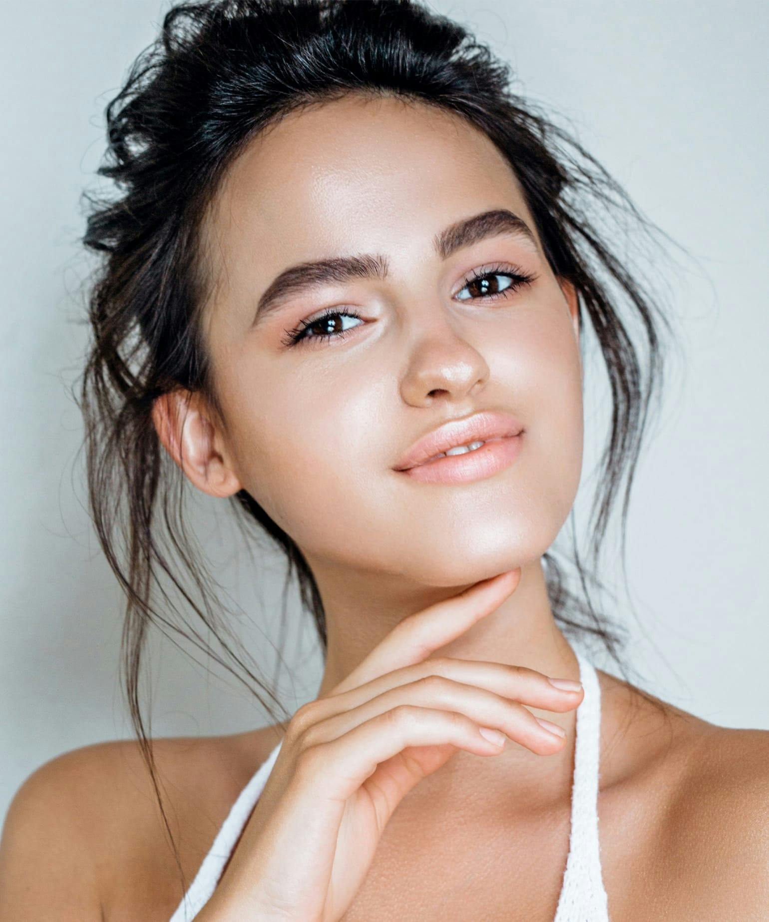 woman touching her chin with her finger