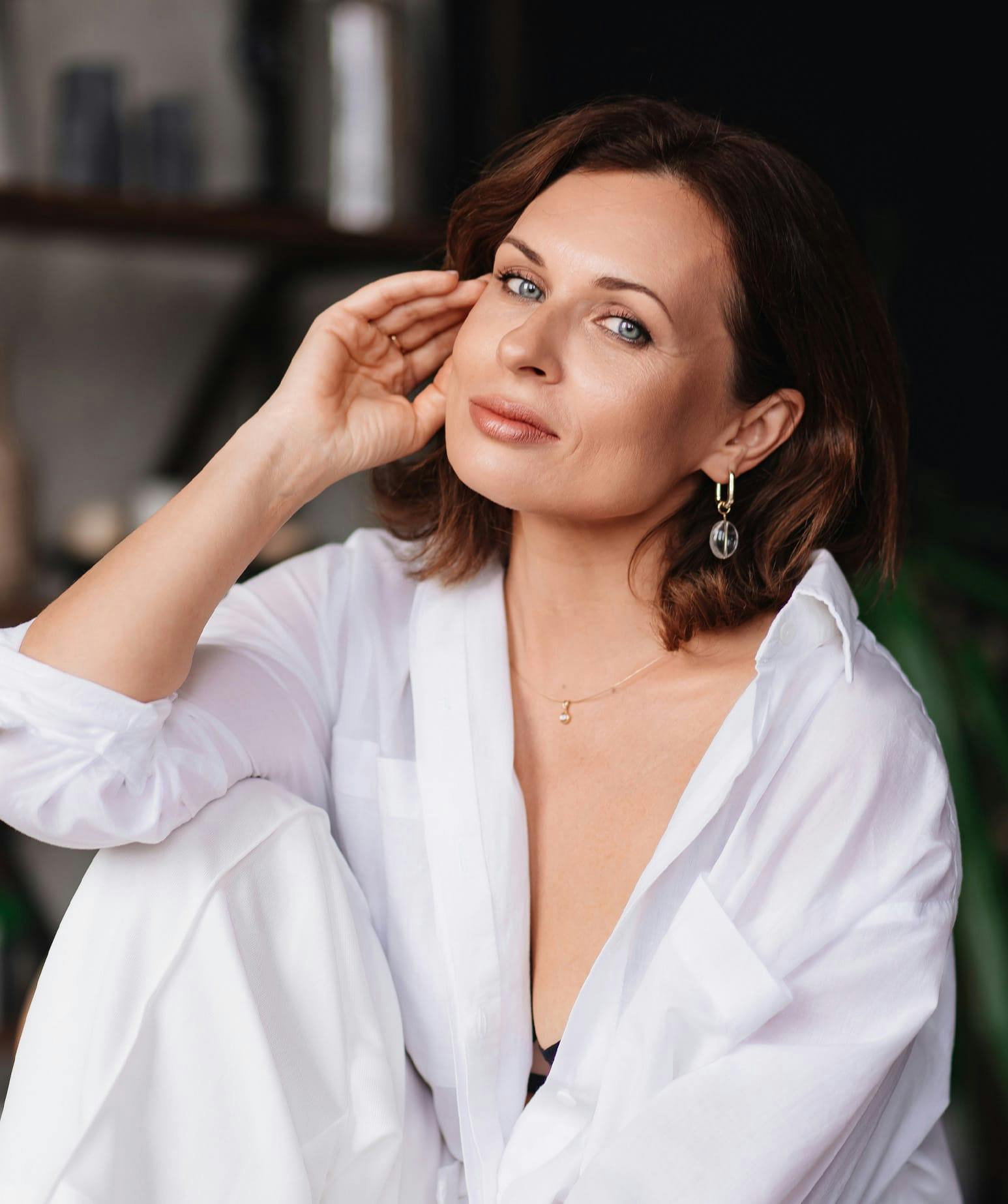 woman sitting down leaning her head on her hand