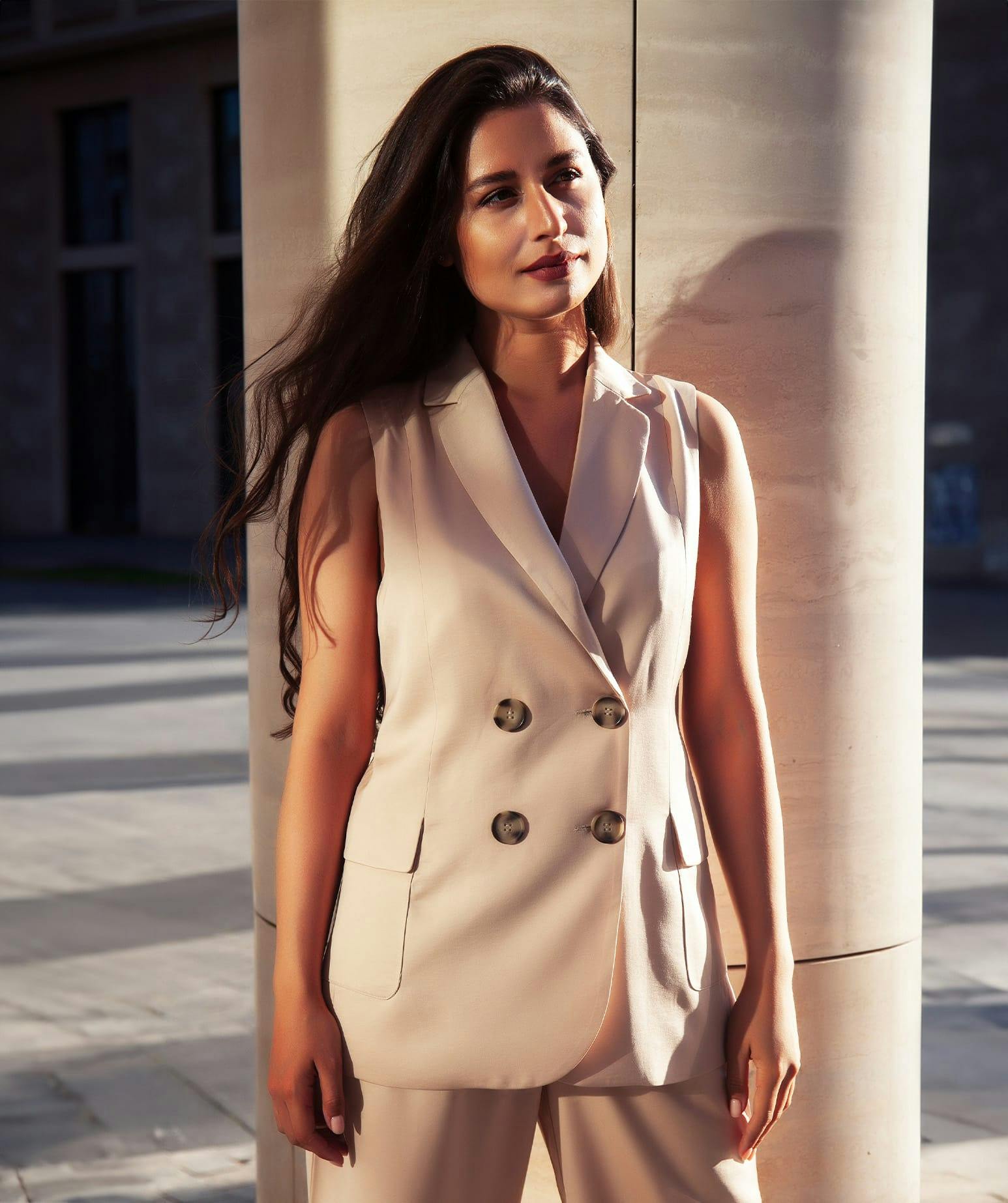 woman standing by a pillar
