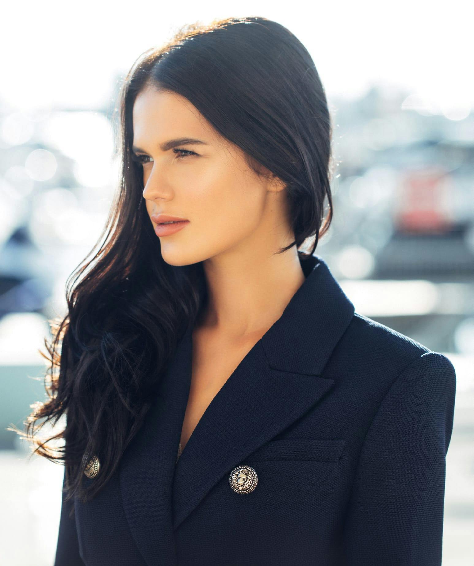 woman with long black hair standing outside