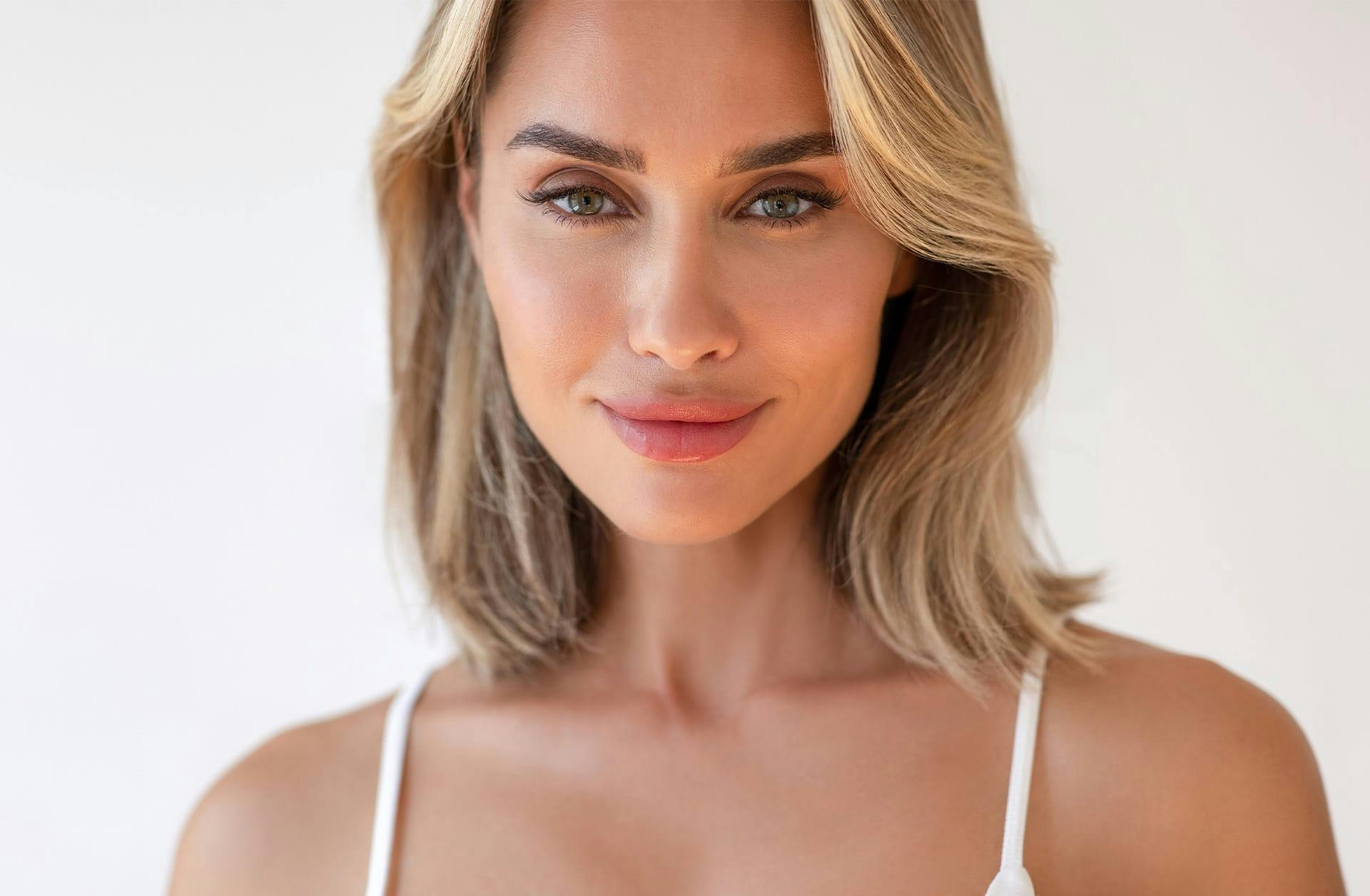 woman with short blonde hair smiling