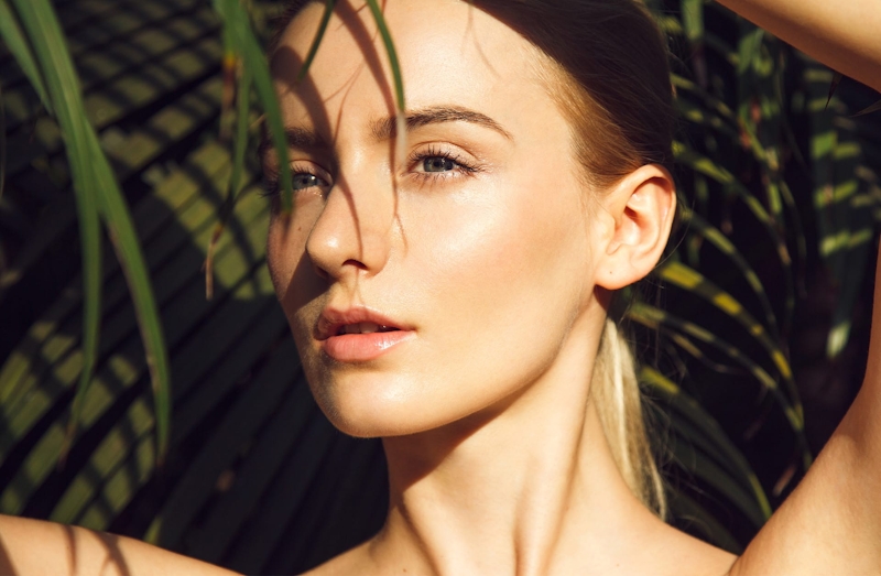 woman with palm fronds around her face