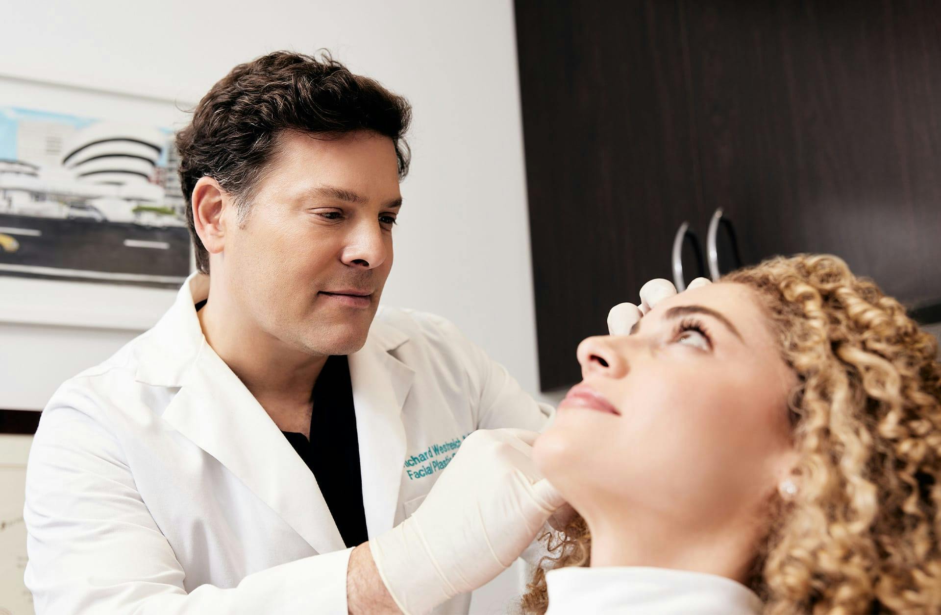 Dr. Westreich touching a patient's face