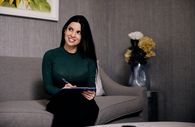 woman writing on a clipboard