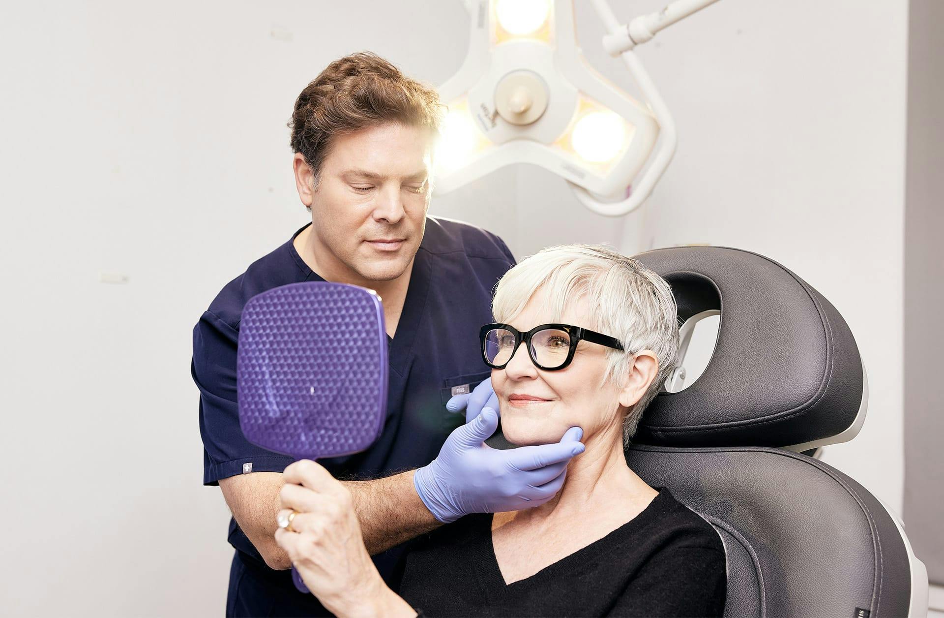 doctor and patient looking into a mirror