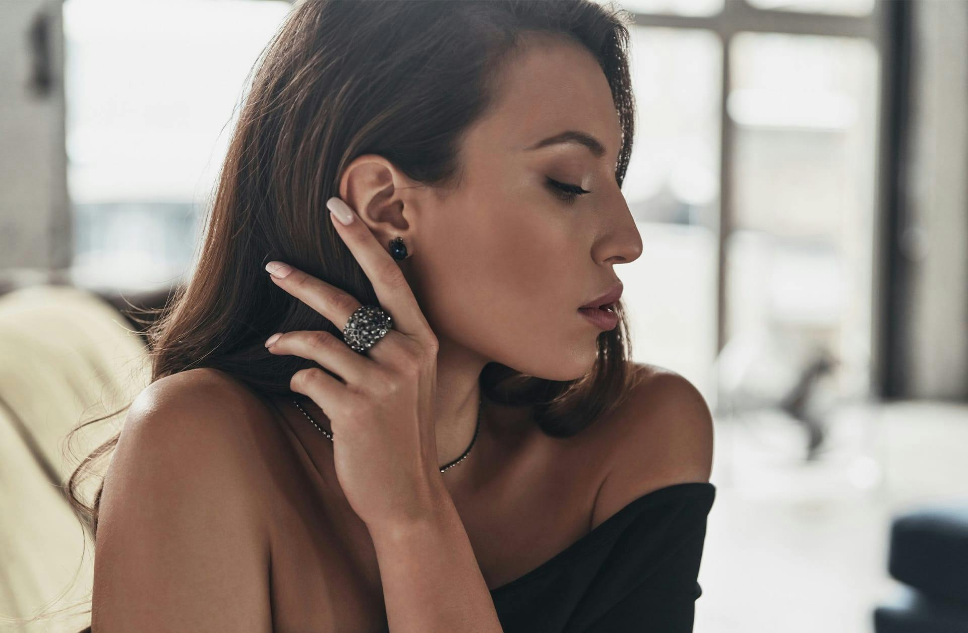 woman tucking her hair behind her ear