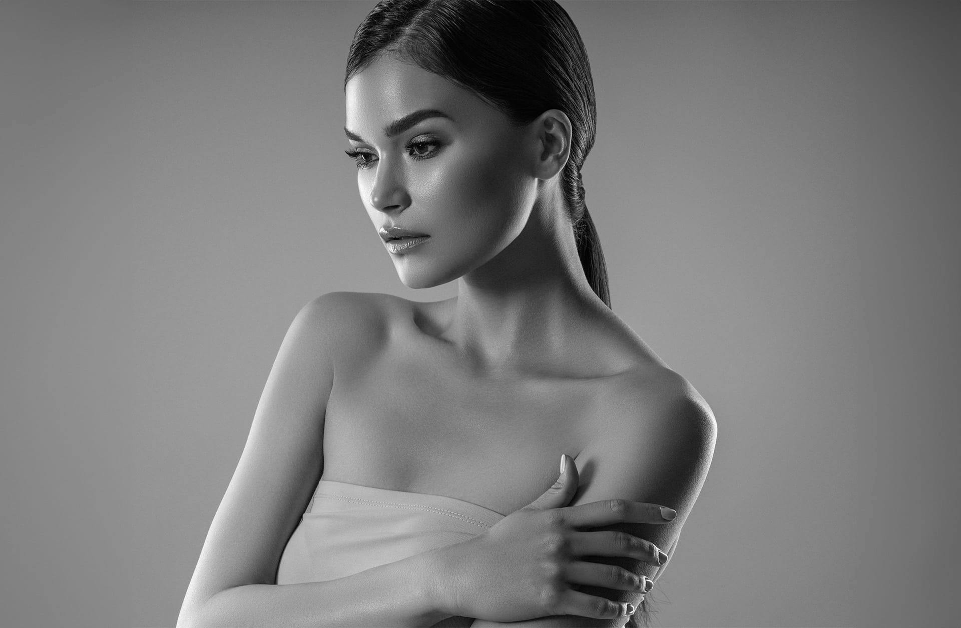woman holding her shoulder