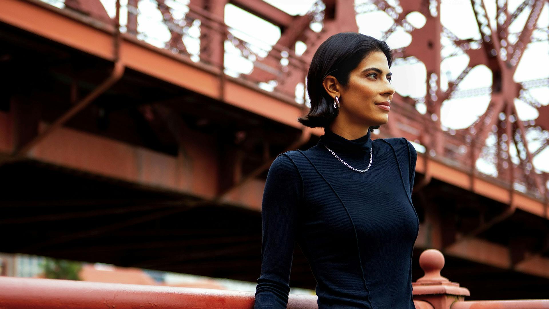 Woman standing by a bridge