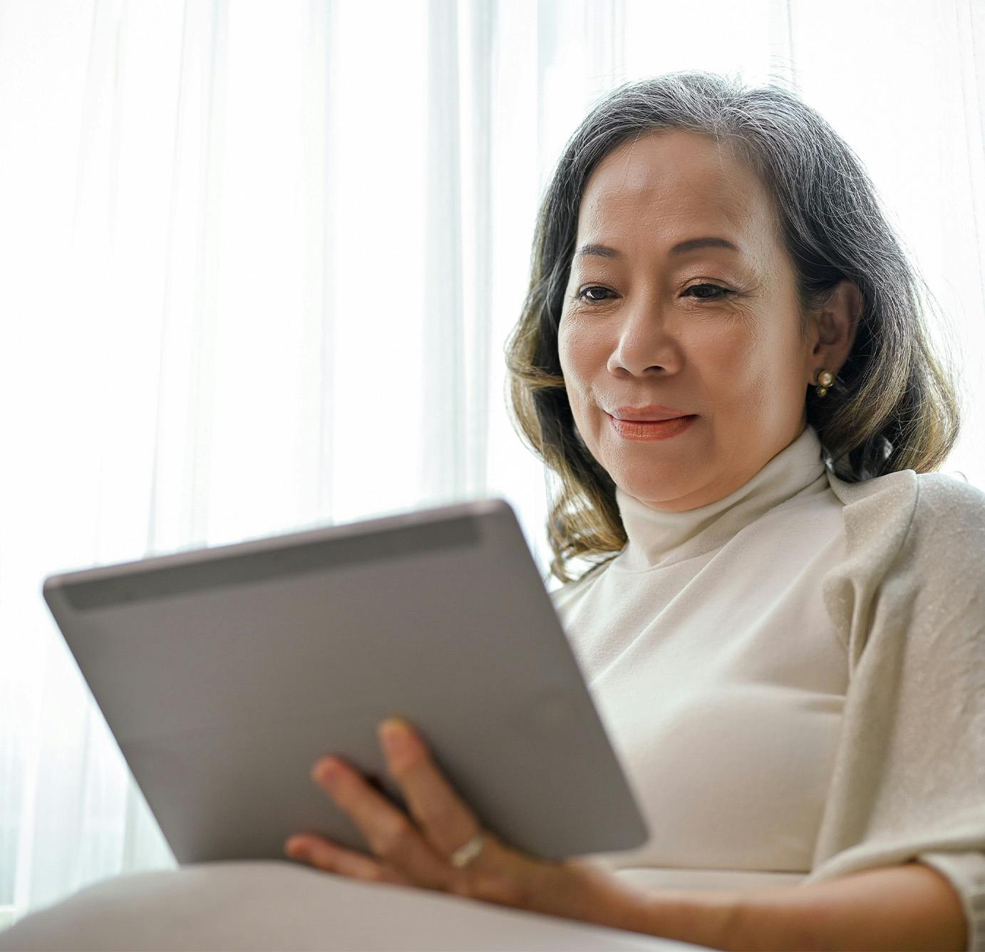 older woman looking at ipad