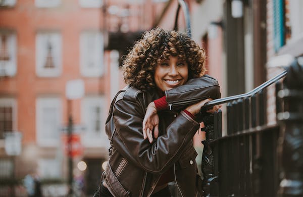 lady resting on fence