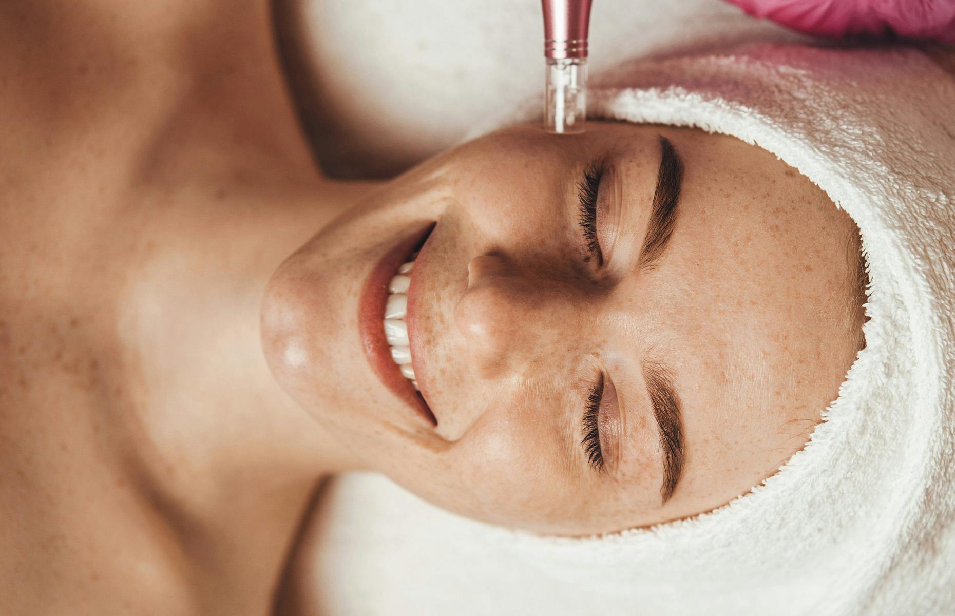 client laying down and smiling during procedure