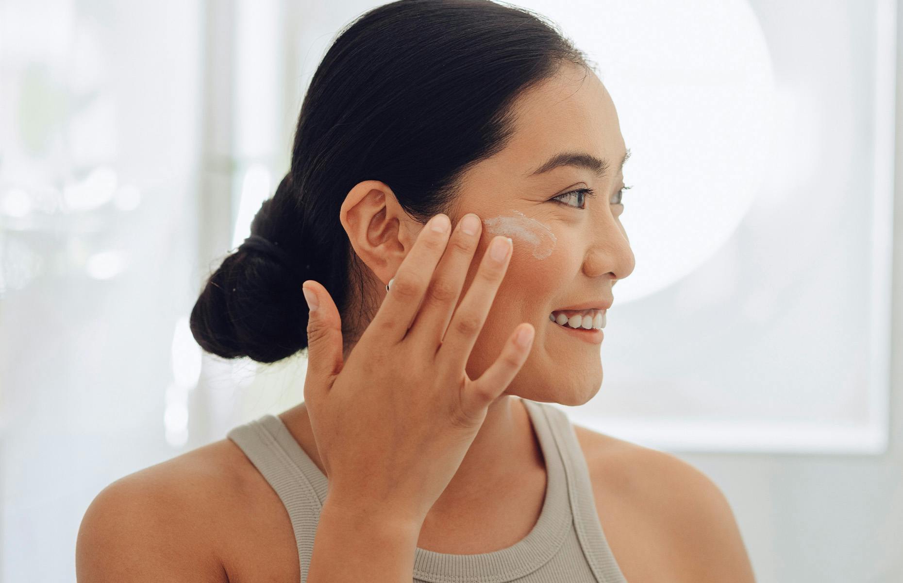 woman looking away with products on her face