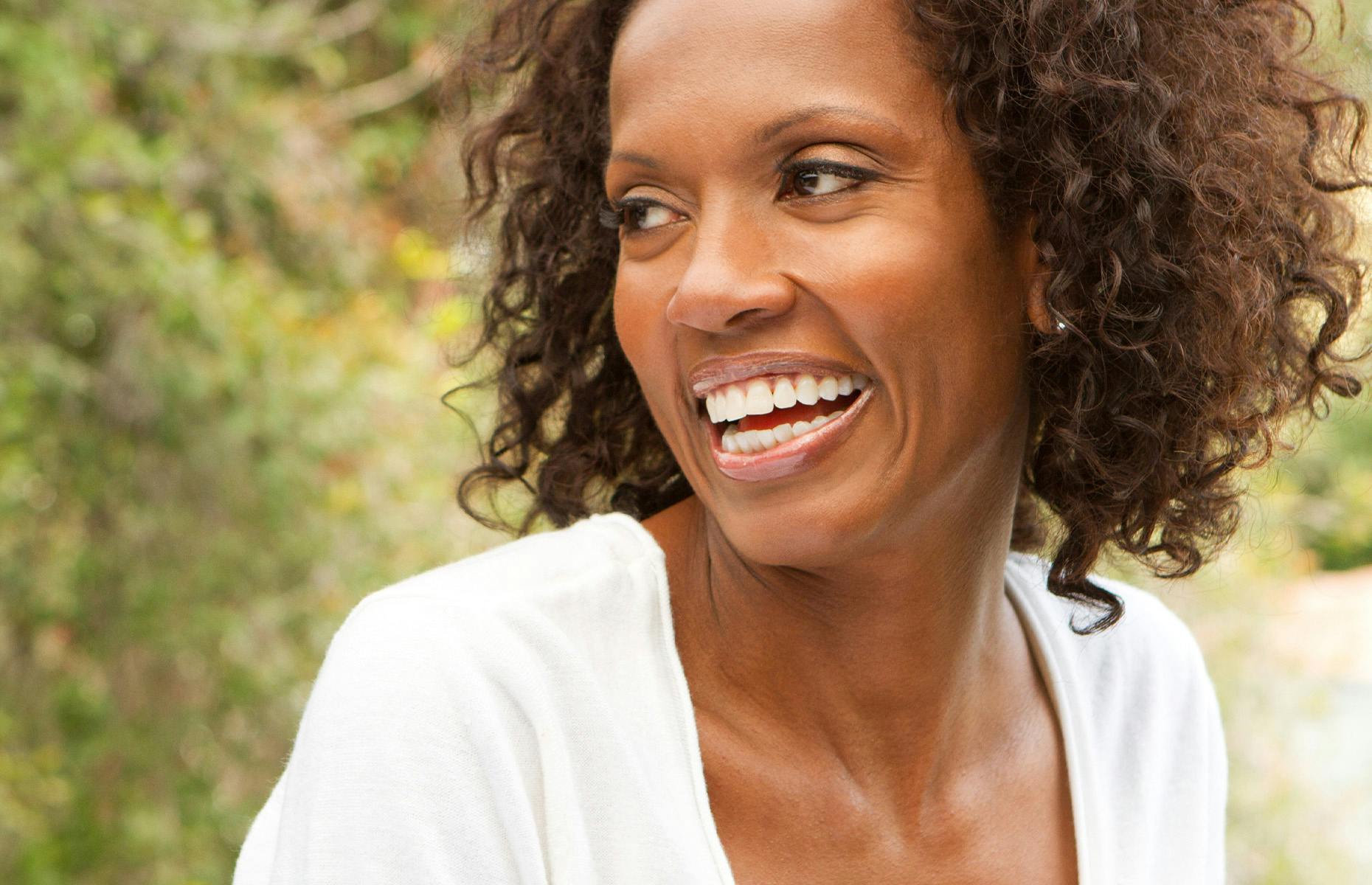 older woman smiling away from camera