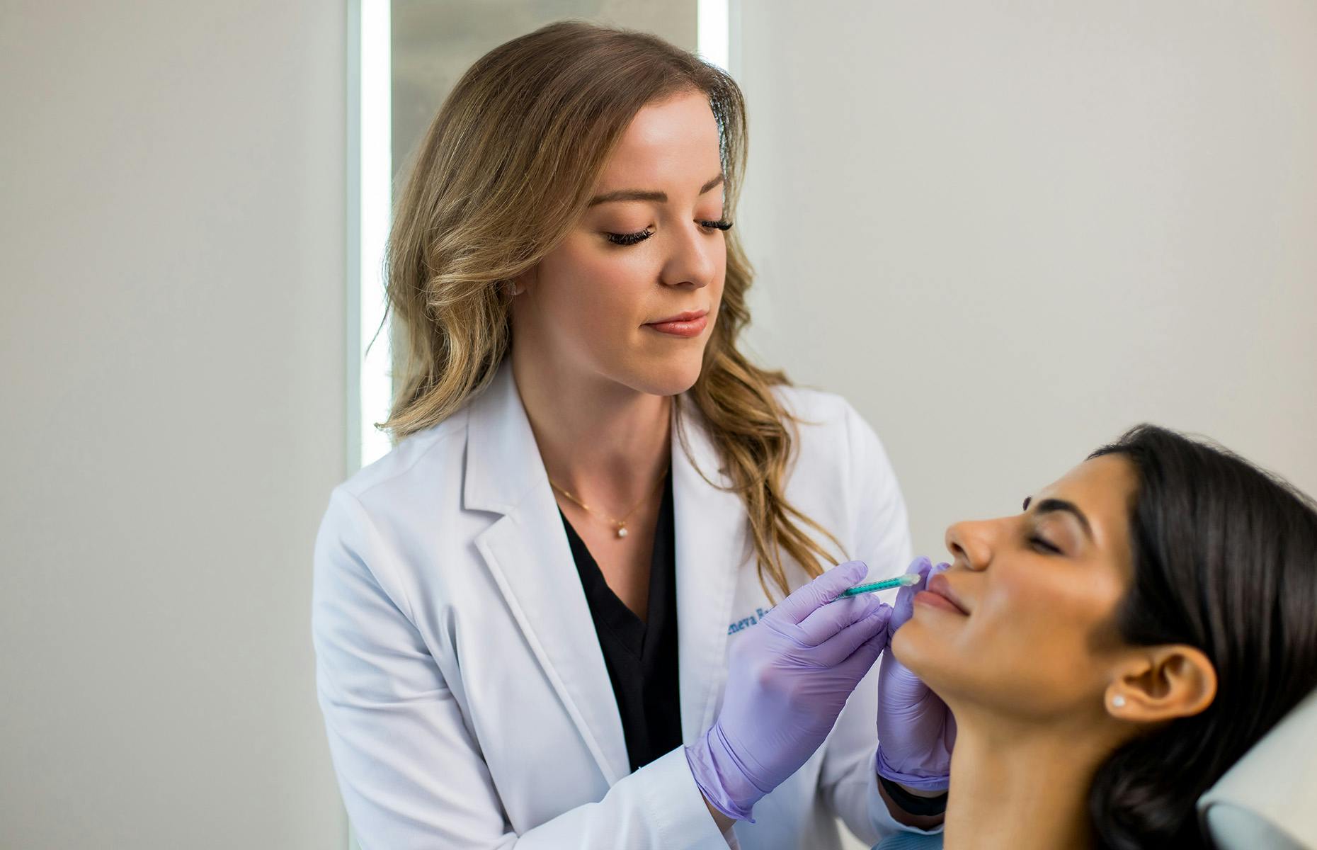 Geneva about to insert syringe in client's lip