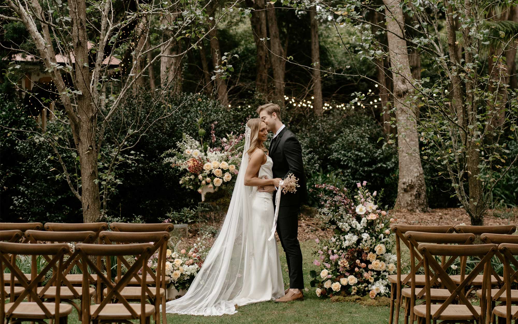 trent and jessie, our bride and groom in the ceremony location of their summer garden wedding