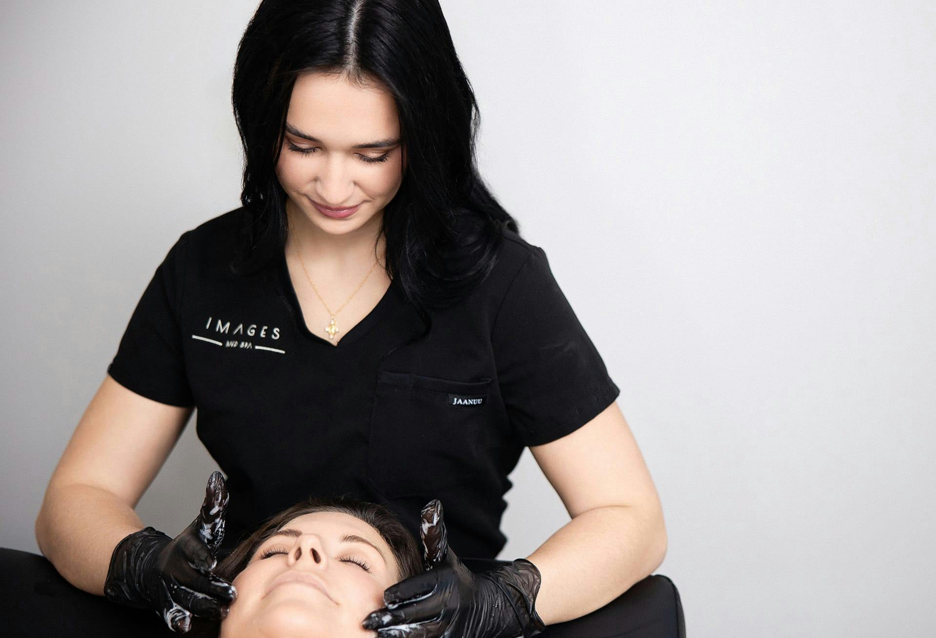 doctor putting cream on client's face