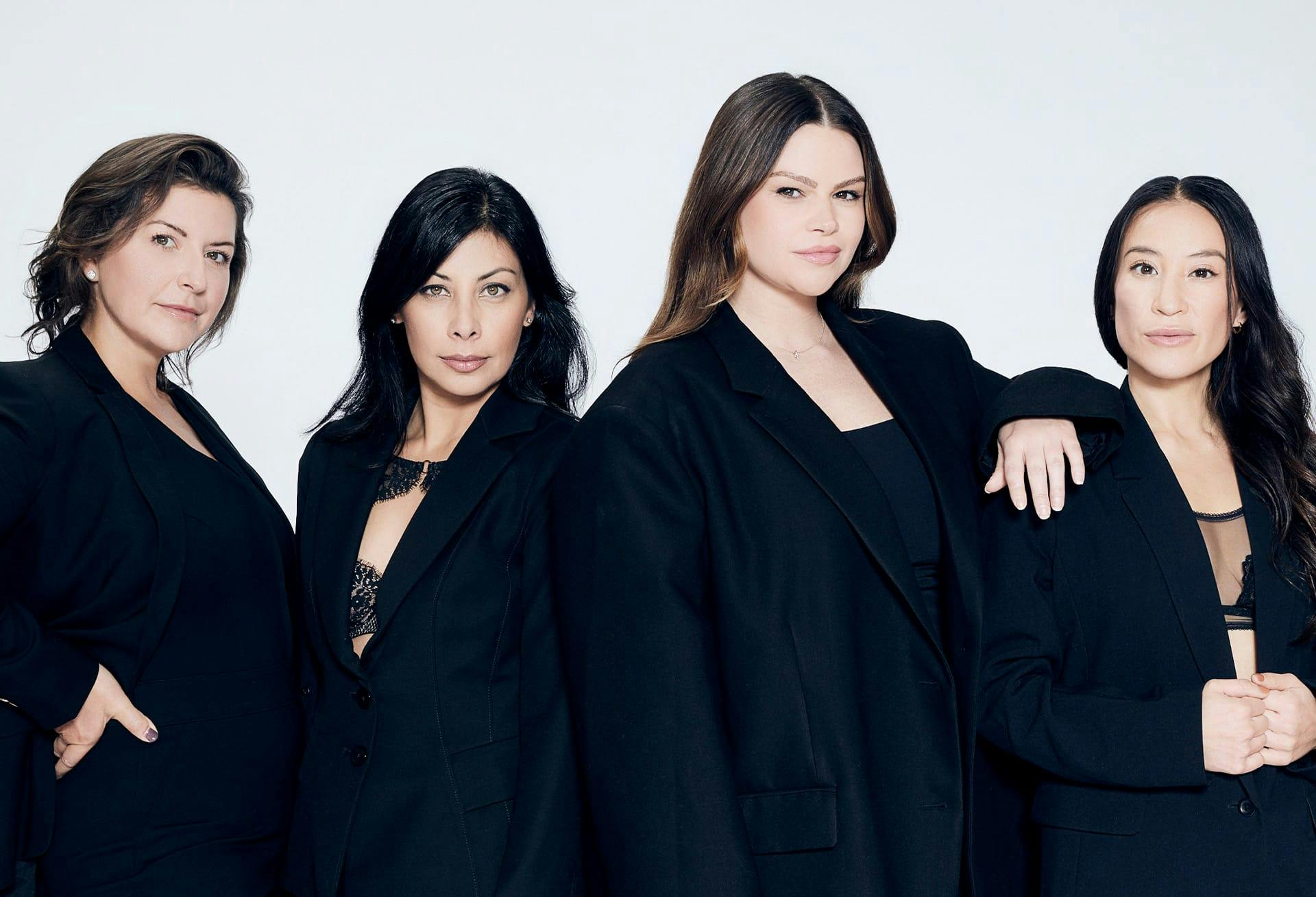 4 ladies of different ages wearing black and posing