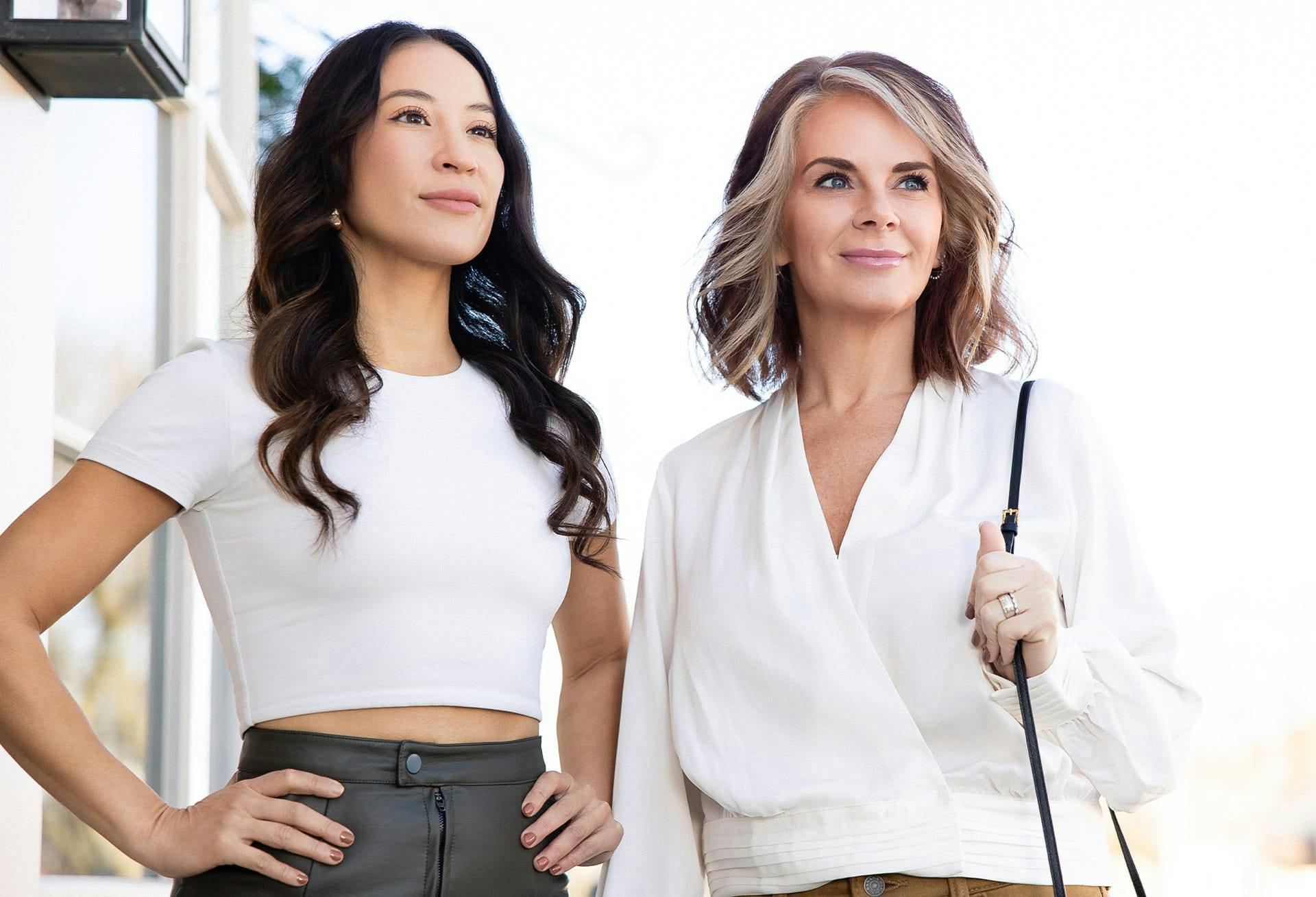 2 women looking past camera posing