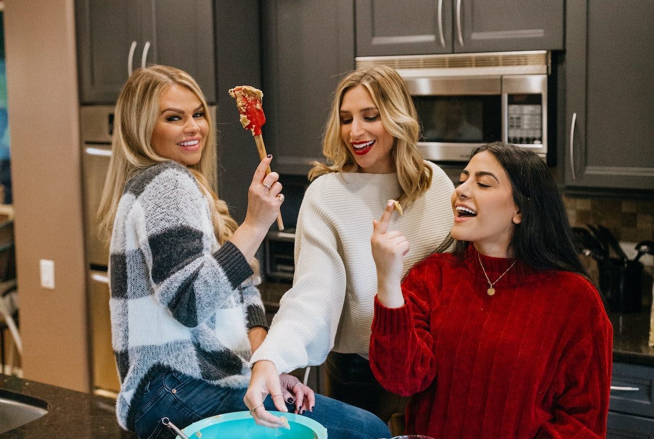women laughing in a kitchen
