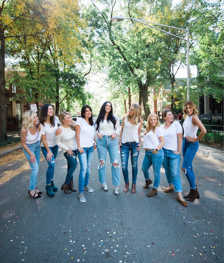 group of women wearing white shirts and blue jeans