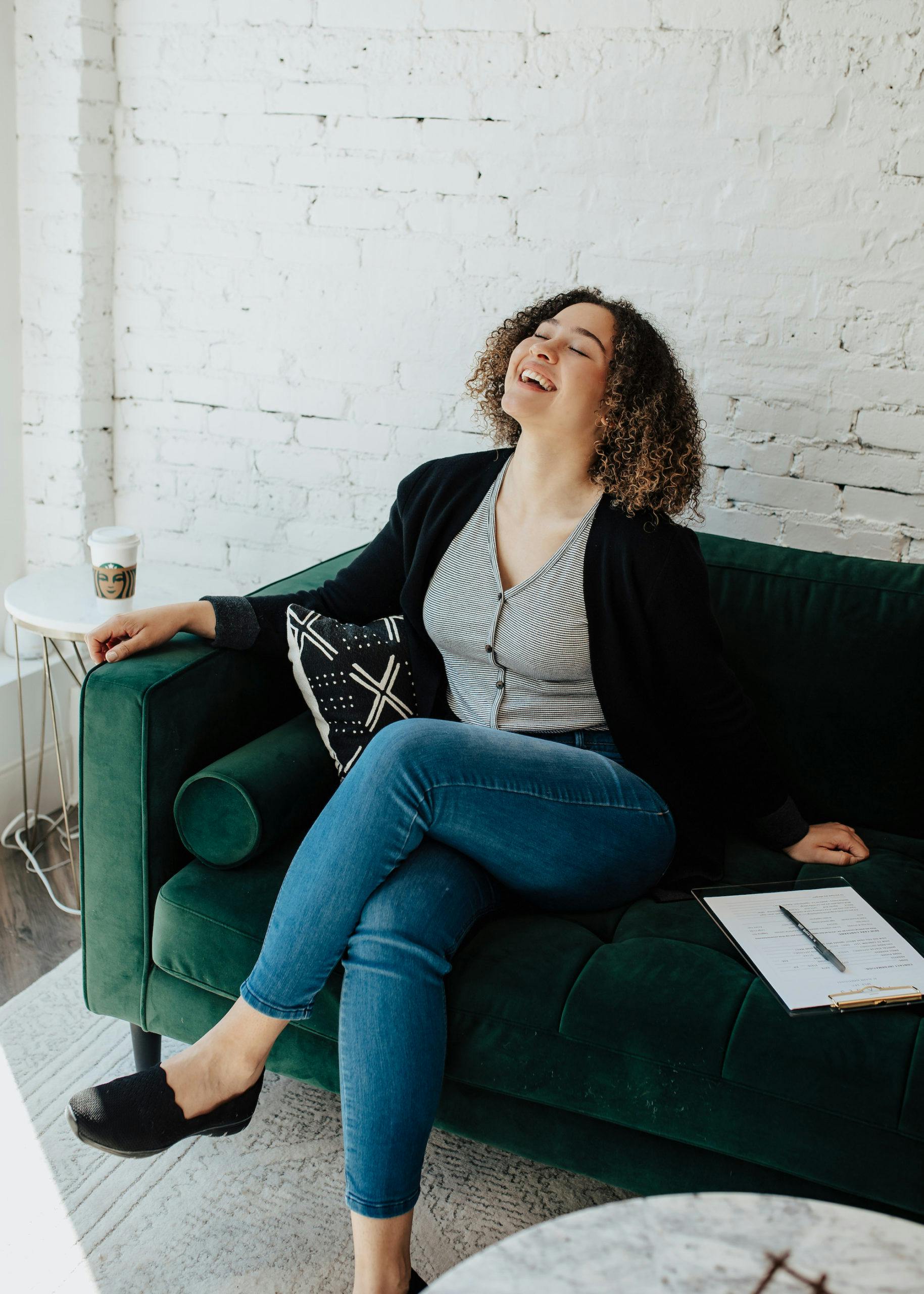 woman sitting on a green couch